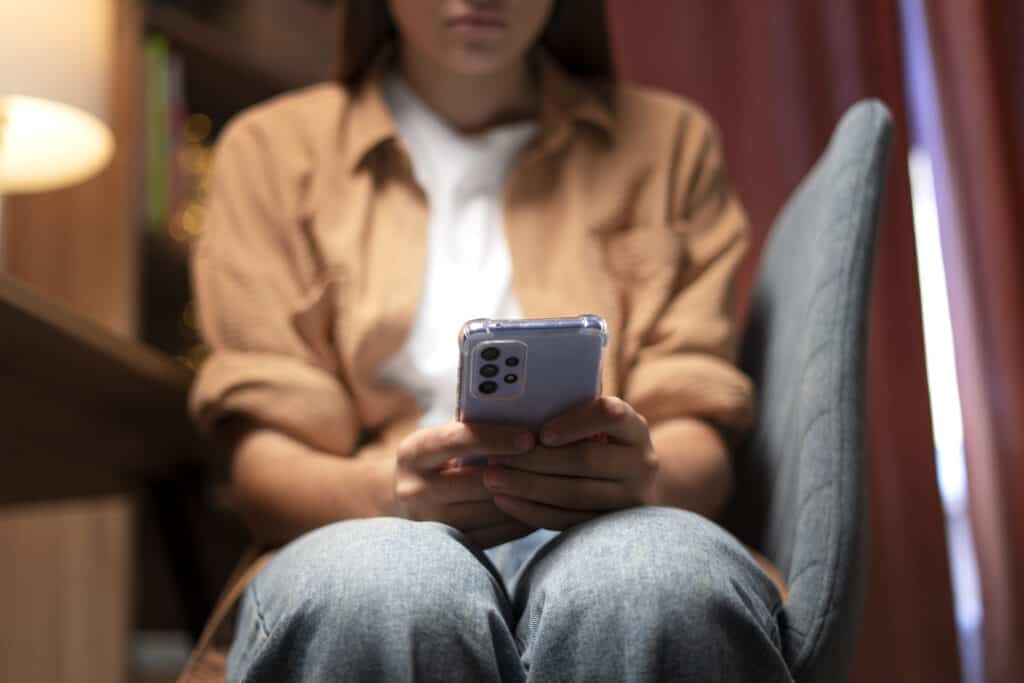 Girl looking disenchanted with social media on her phone, discovering websites offer superior digital marketing tactics.